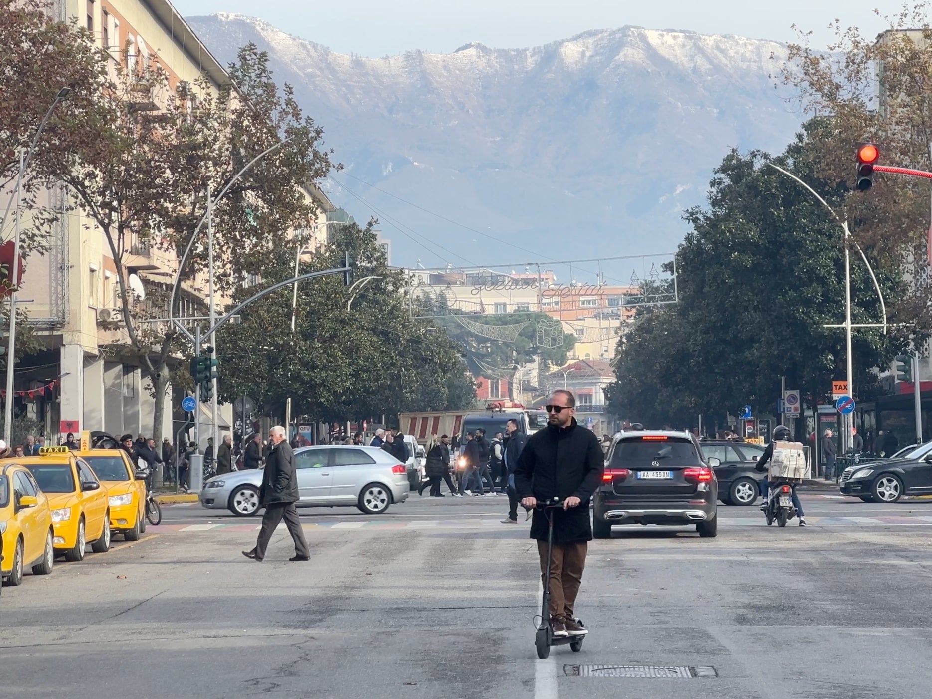 Opening up: Tirana street scene, dominated by snow-capped mountains