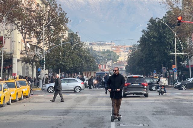 <p>Opening up: Tirana street scene, dominated by snow-capped mountains</p>