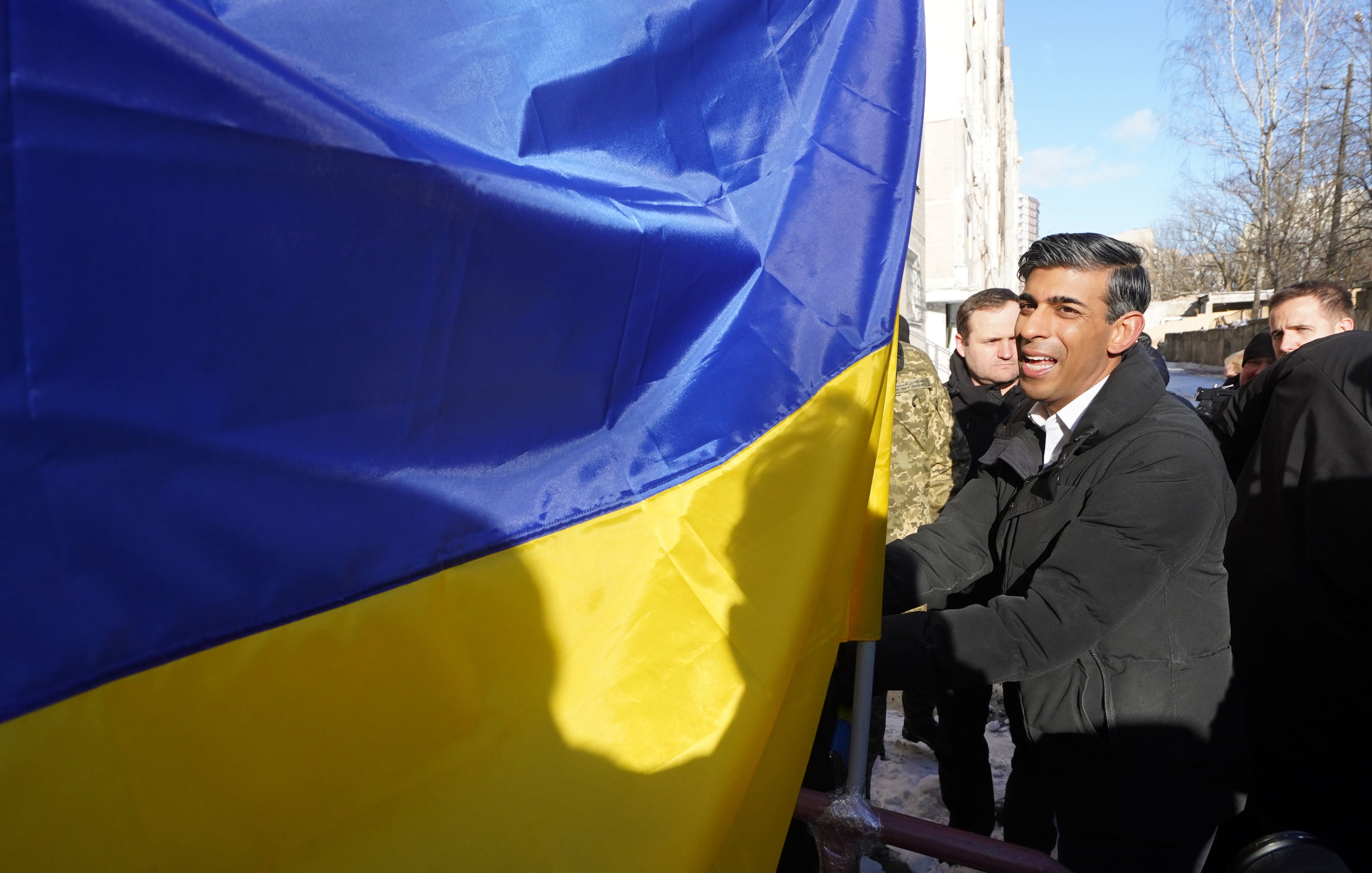 Rishi Sunak with the Ukrainian flag as he talks to members of the public in Kyiv