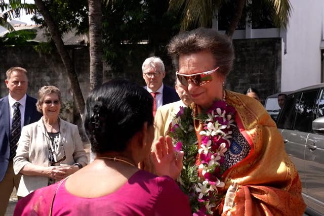 <p>Princess Anne dons flower garland and husband smashes coconut during Hindu Temple visit.</p>