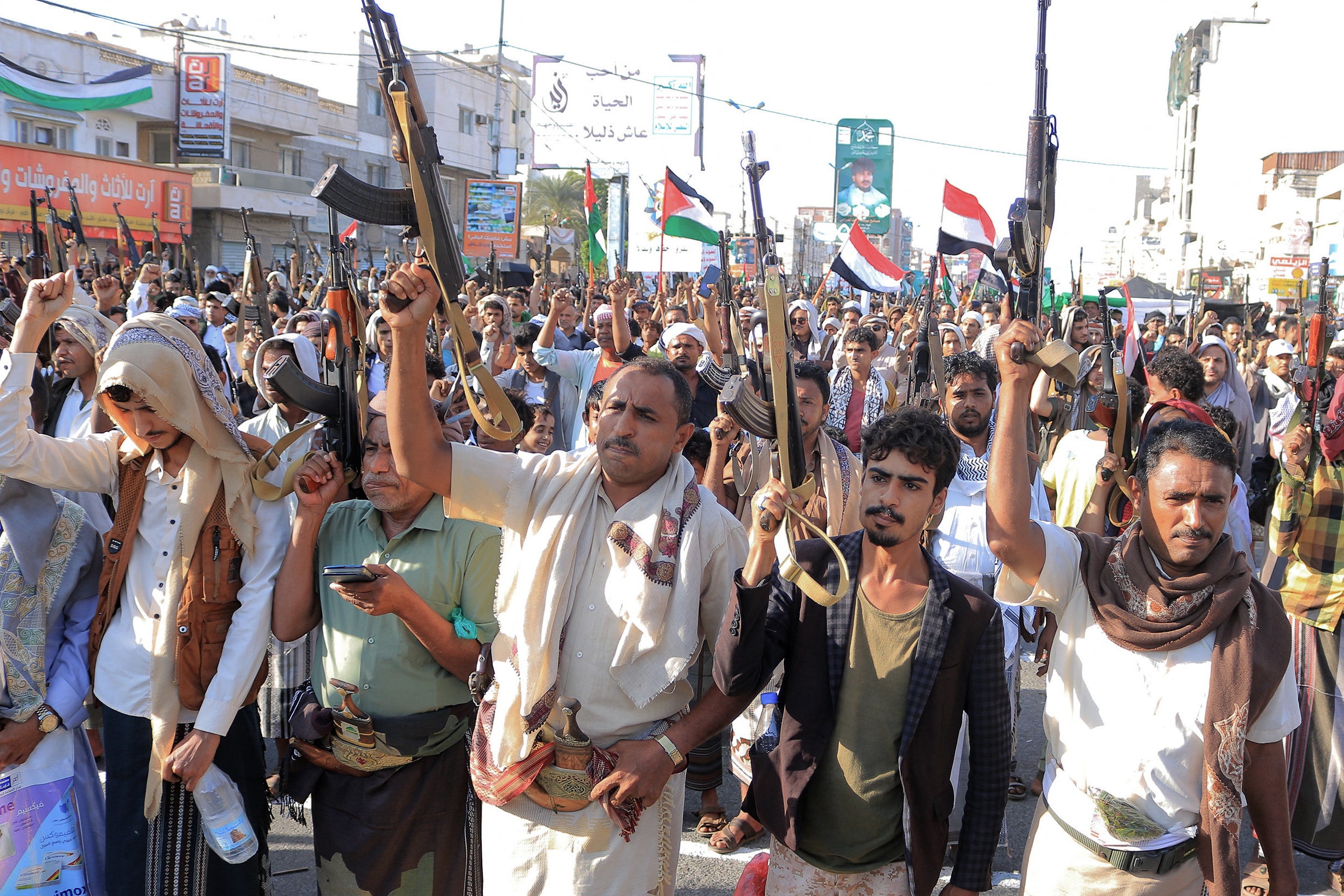 People take part in a protest on the streets of the Yemeni Red Sea city of Hodeidah