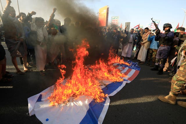 <p>Protesters burn Israeli and US flags in Yemen yesterday after US and UK airstrikes on Houthi military sites</p>