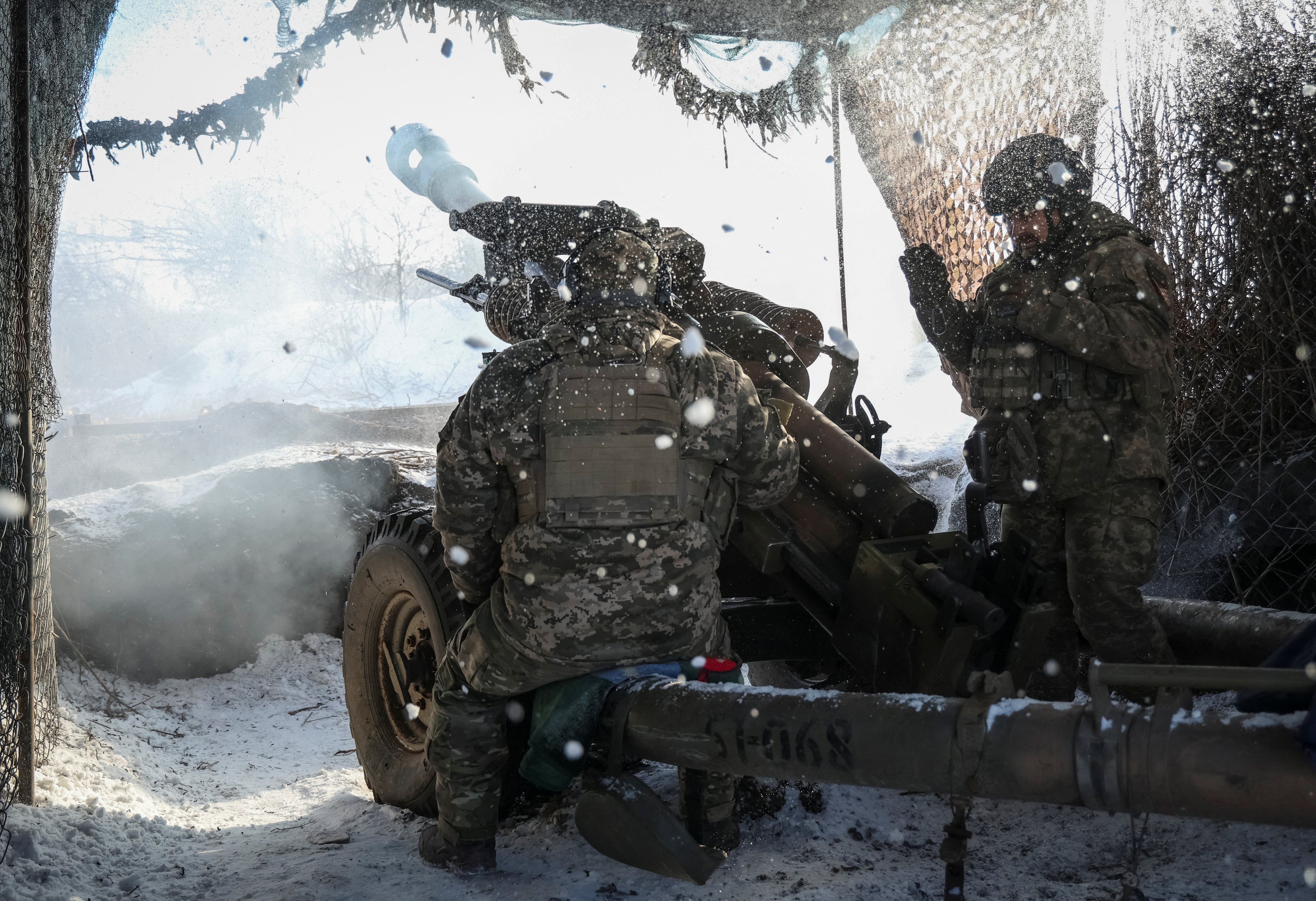 Ukrainian service members of 79th brigade fire a L119 howitzer towards Russian troops near the front line town of Marinka, amid Russia's attack on Ukraine, in Donetsk region, Ukraine January 12, 2024
