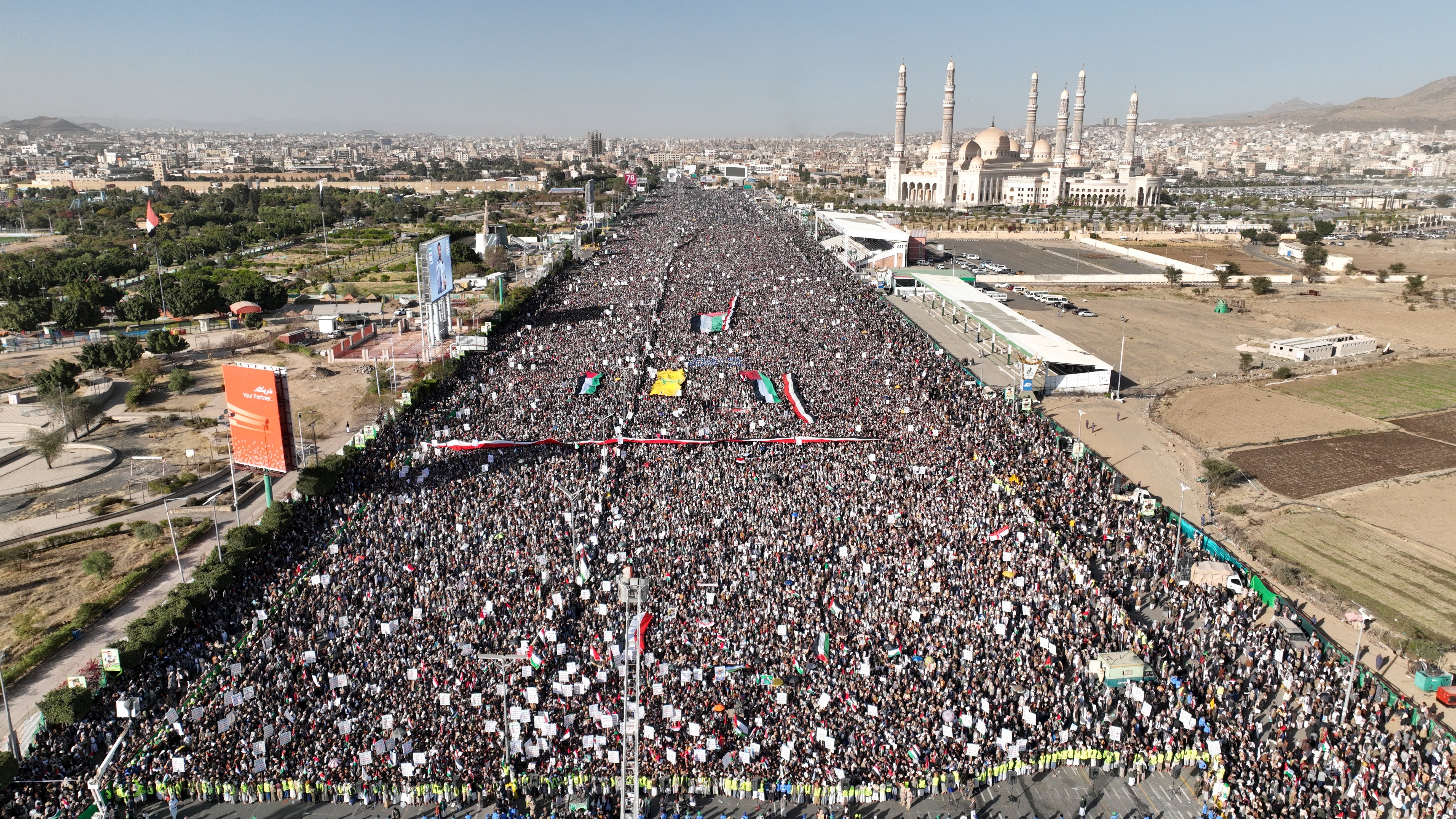 A drone view as Houthi movement supporters rally to denounce air strikes launched by the US and Britain on Houthi targets, in Sanaa, Yemen, 12 January 2024