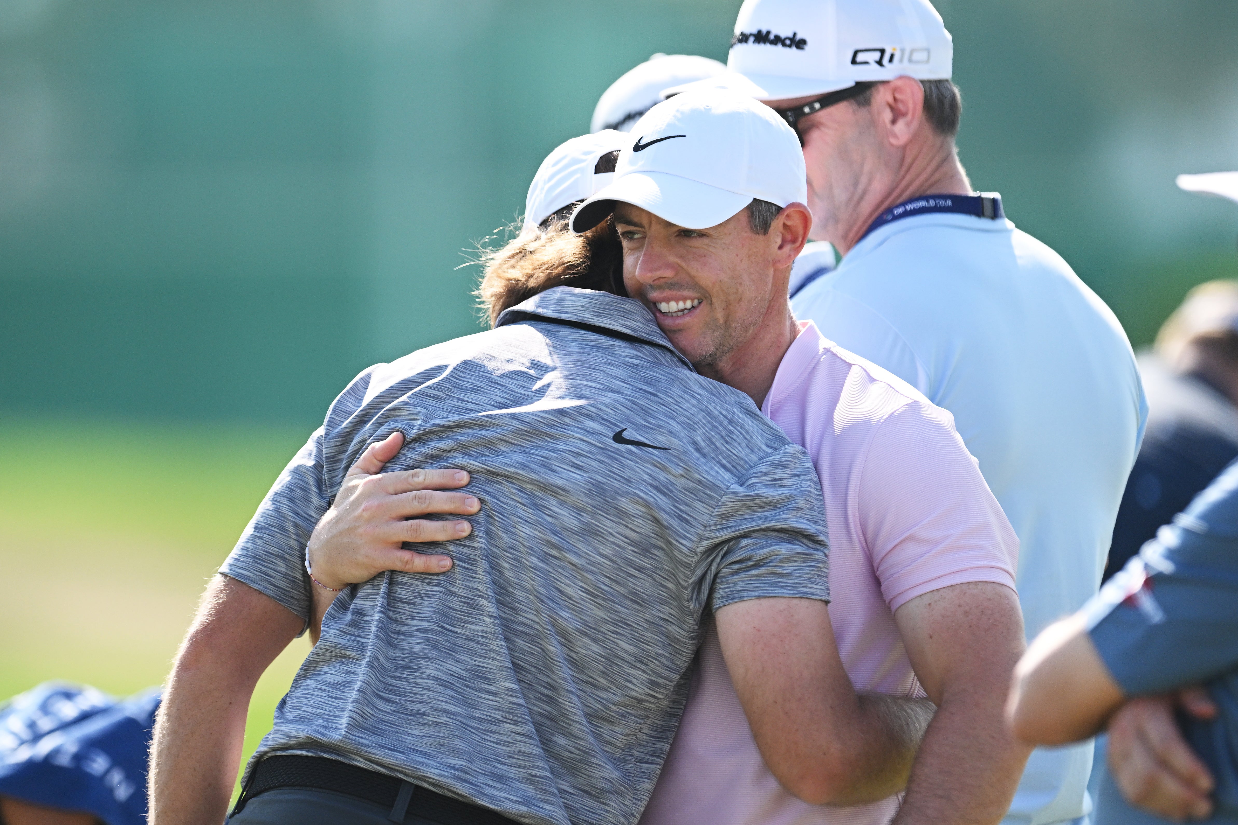 McIlroy and Fleetwood embrace on the range before the Dubai Invitational