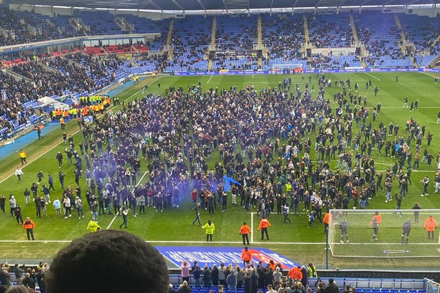 <p>Reading fans stormed the pitch in protest at the club’s owner </p>