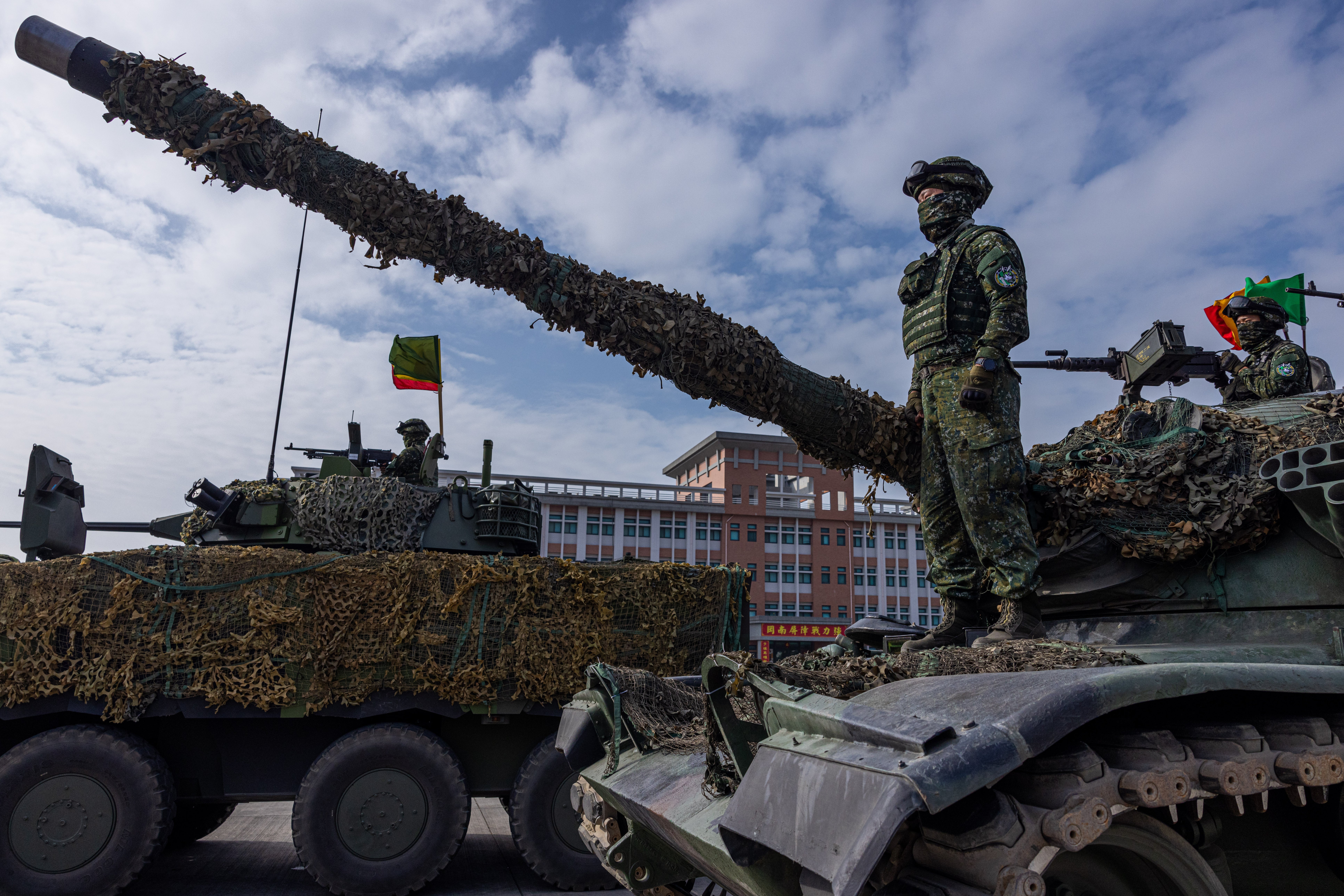 Soldiers stand on the CM-11 Brave Tiger battle tank after drills to show combat readiness in Kaohsiung, Taiwan, last year