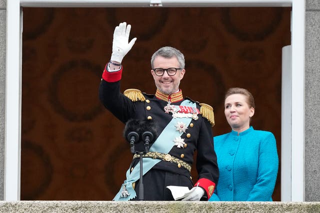 <p>Denmark's King Frederik X waves from the balcony of Christiansborg Palace as Danish prime minister Mette Frederiksen looks on in Copenhagen</p>