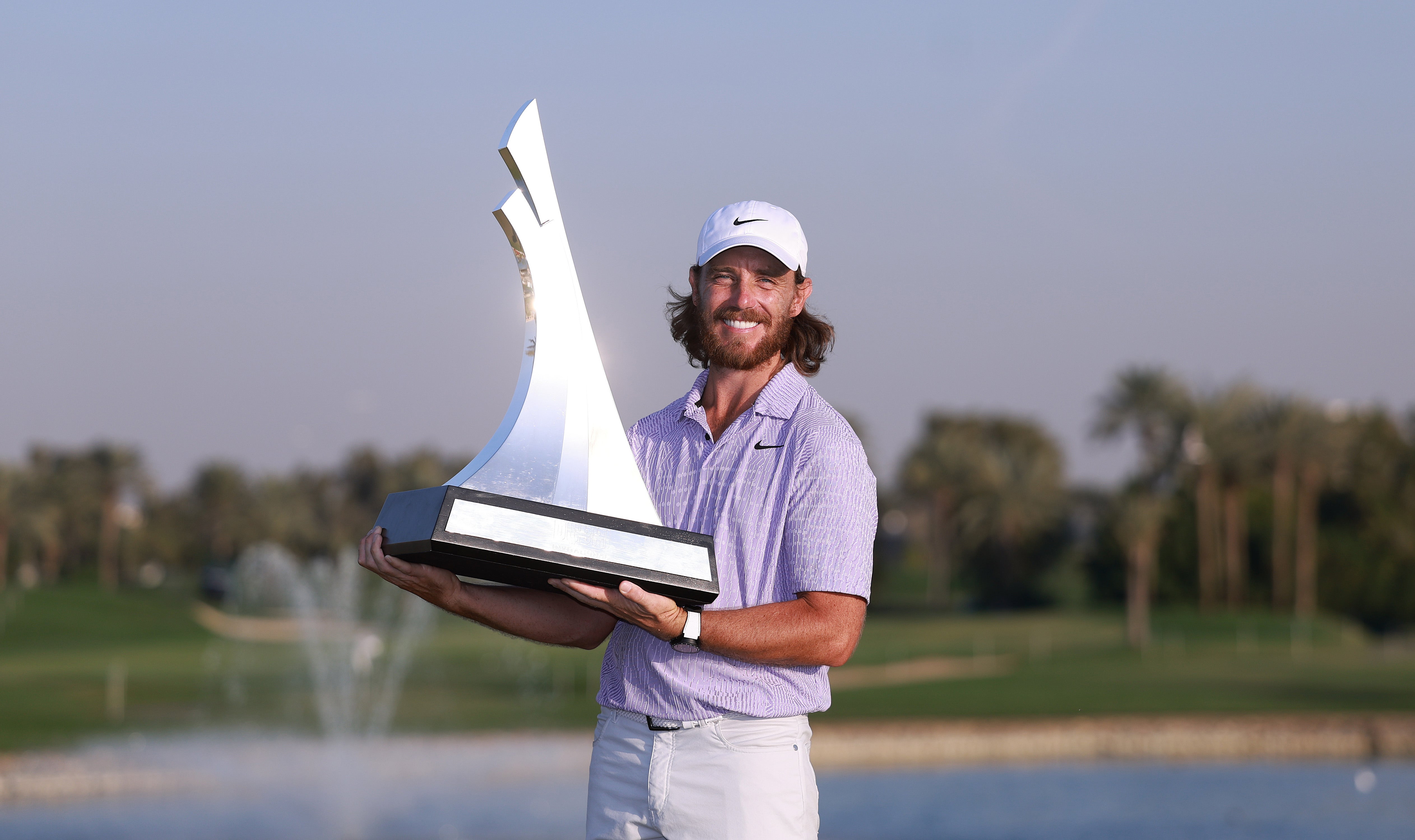 Tommy Fleetwood poses with the trophy after winning the Dubai Invitational at Dubai Creek Golf and Yacht Club