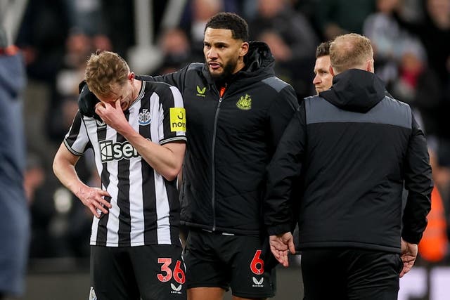 <p>Sean Longstaff is consoled after a heatbreaking defeat by Manchester City</p>