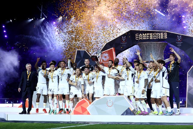 <p>Real Madrid celebrate with the trophy in Riyadh</p>