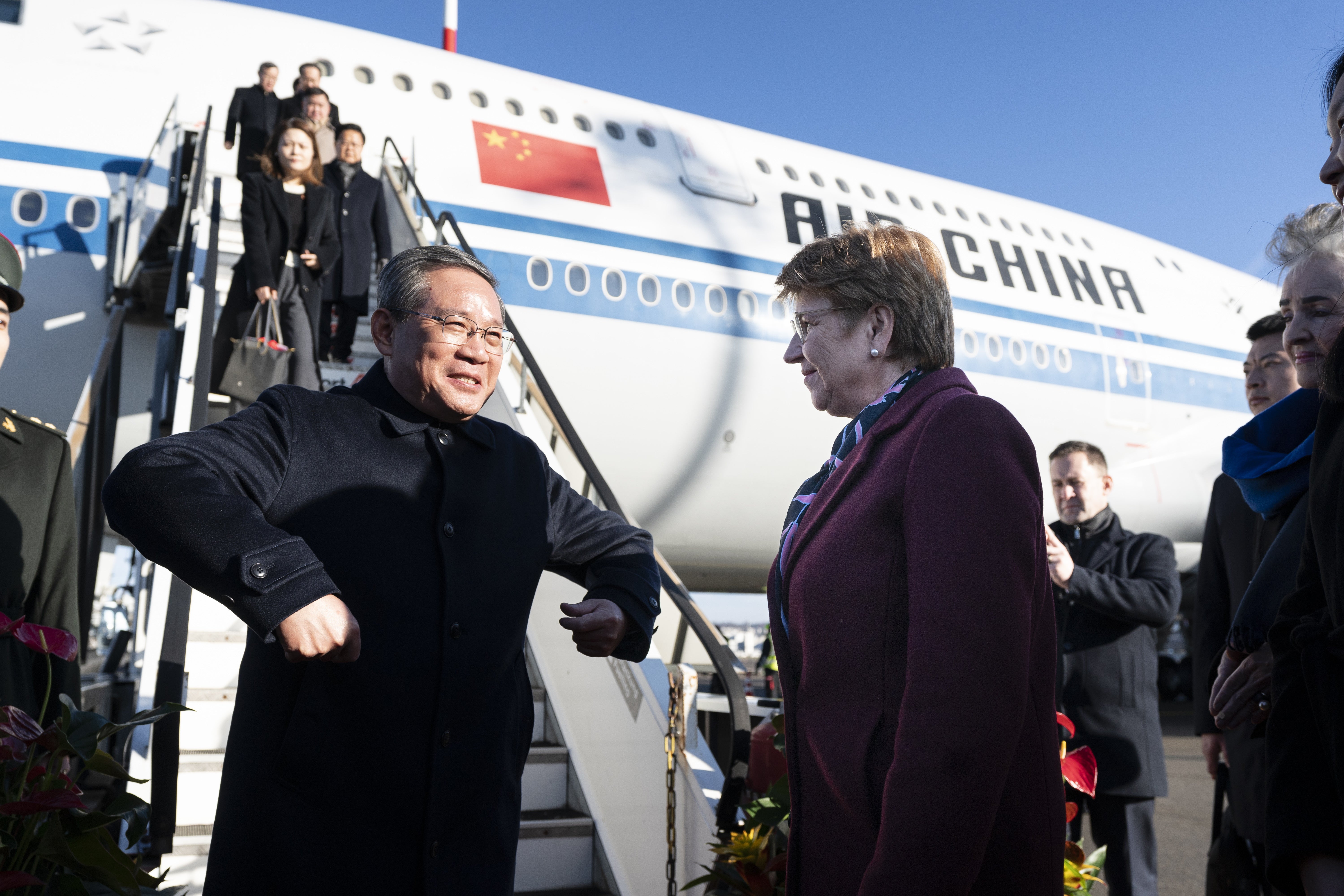 Swiss President Viola Amherd (R) welcomes Chinese Prime Minister Li Qiang (L) and his delegation upon their arrival at Zurich Airport