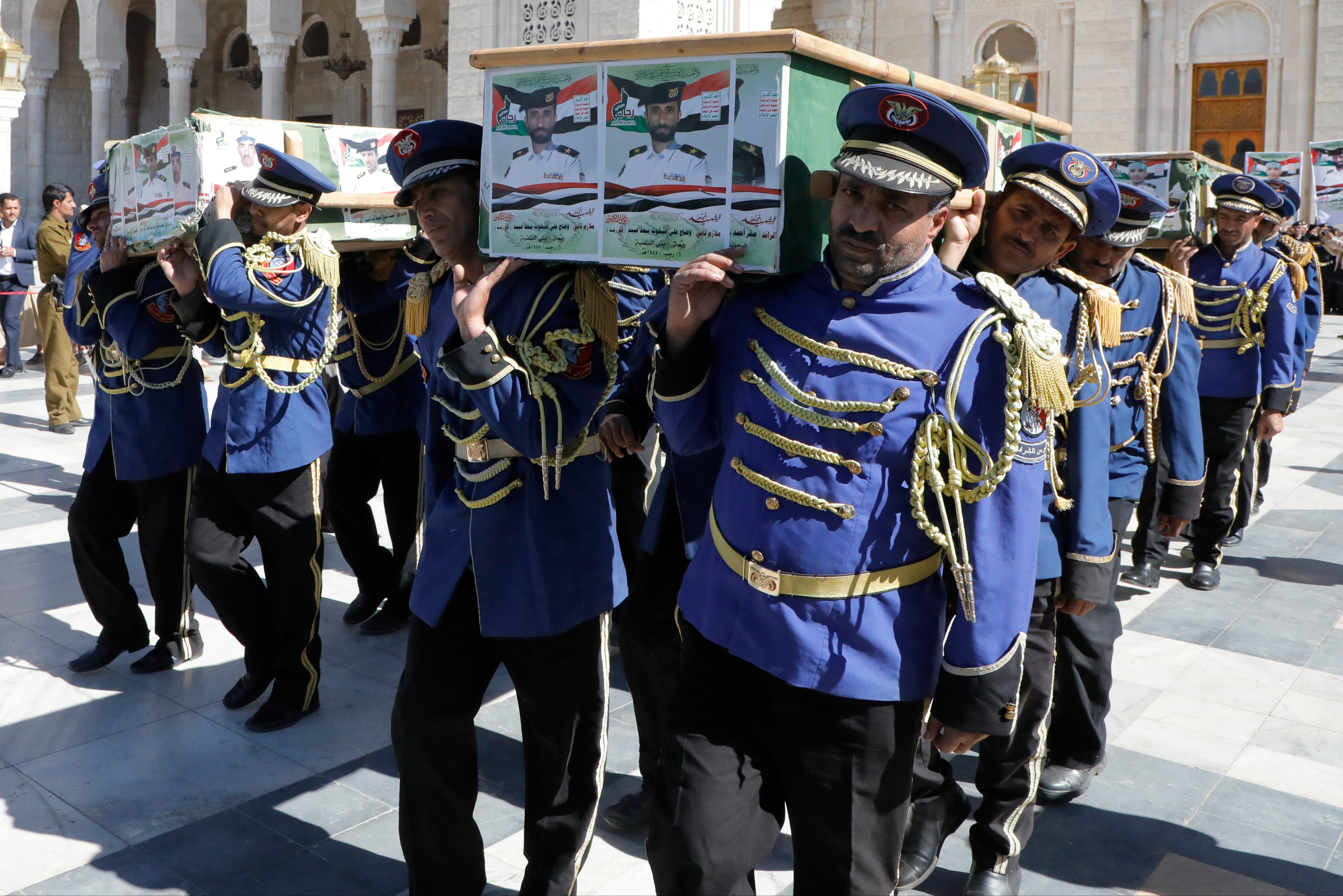 <p>Houthi honor guard carries the coffins of the fighters killed in the US and UK air strikes during their funeral in Yemen</p>