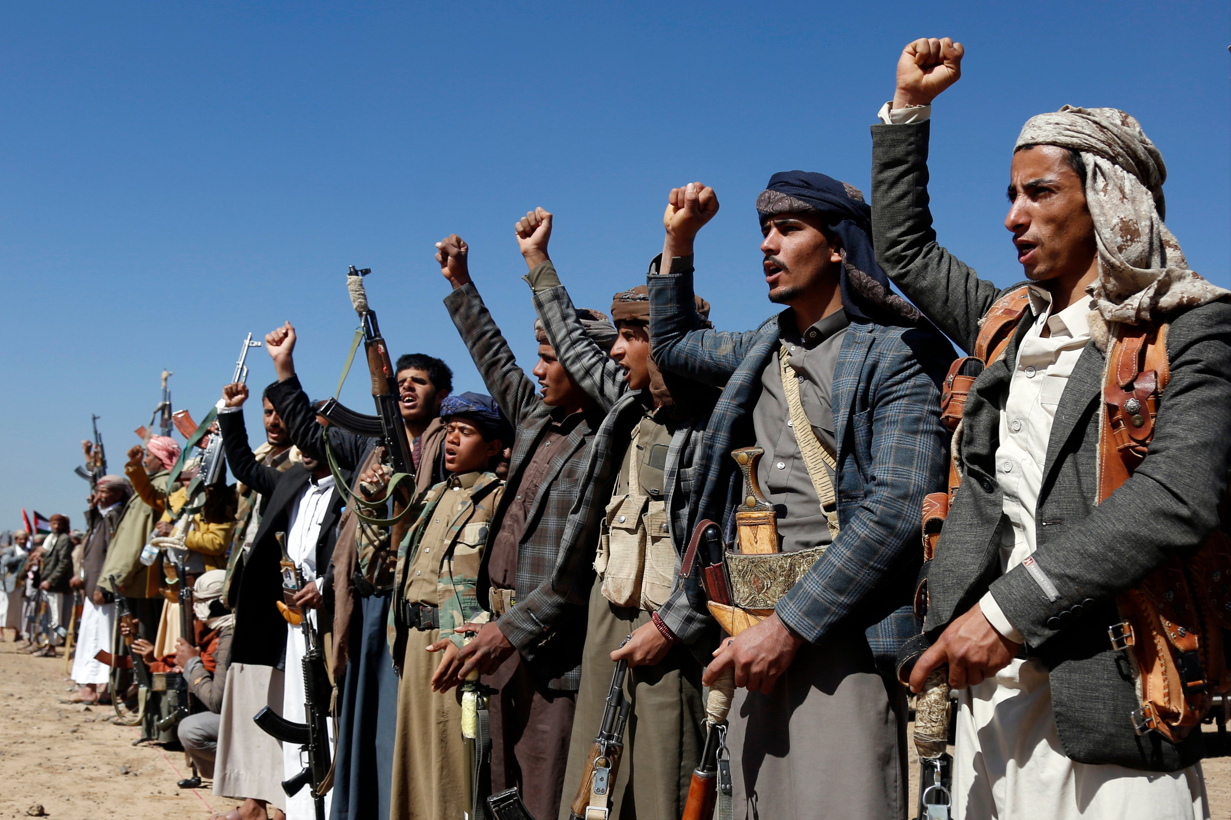 <p>Houthi fighters and tribesmen stage a rally against the US and the UK strikes on Houthi-run military sites near Sanaa, Yemen</p>