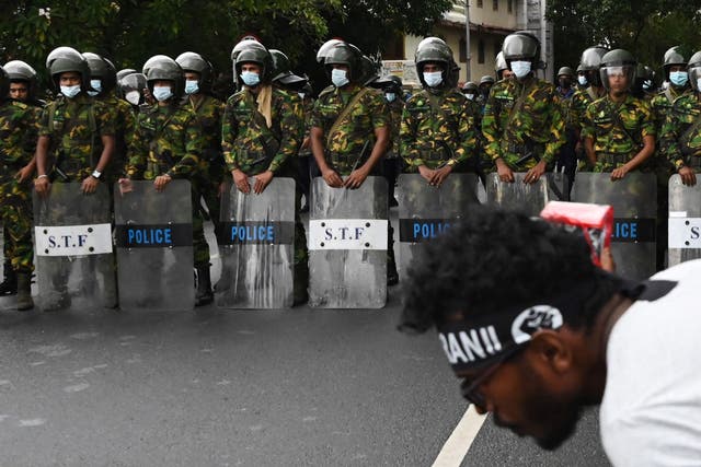<p>File: Police special task force personnel stand guard as demonstrators take part in a protest </p>