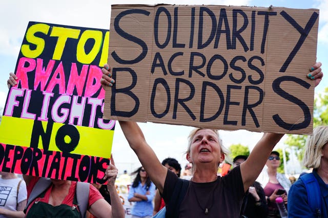 <p>Demonstrators at a removal centre at Gatwick protest against plans to send migrants to Rwanda (Victoria Jones/PA)</p>