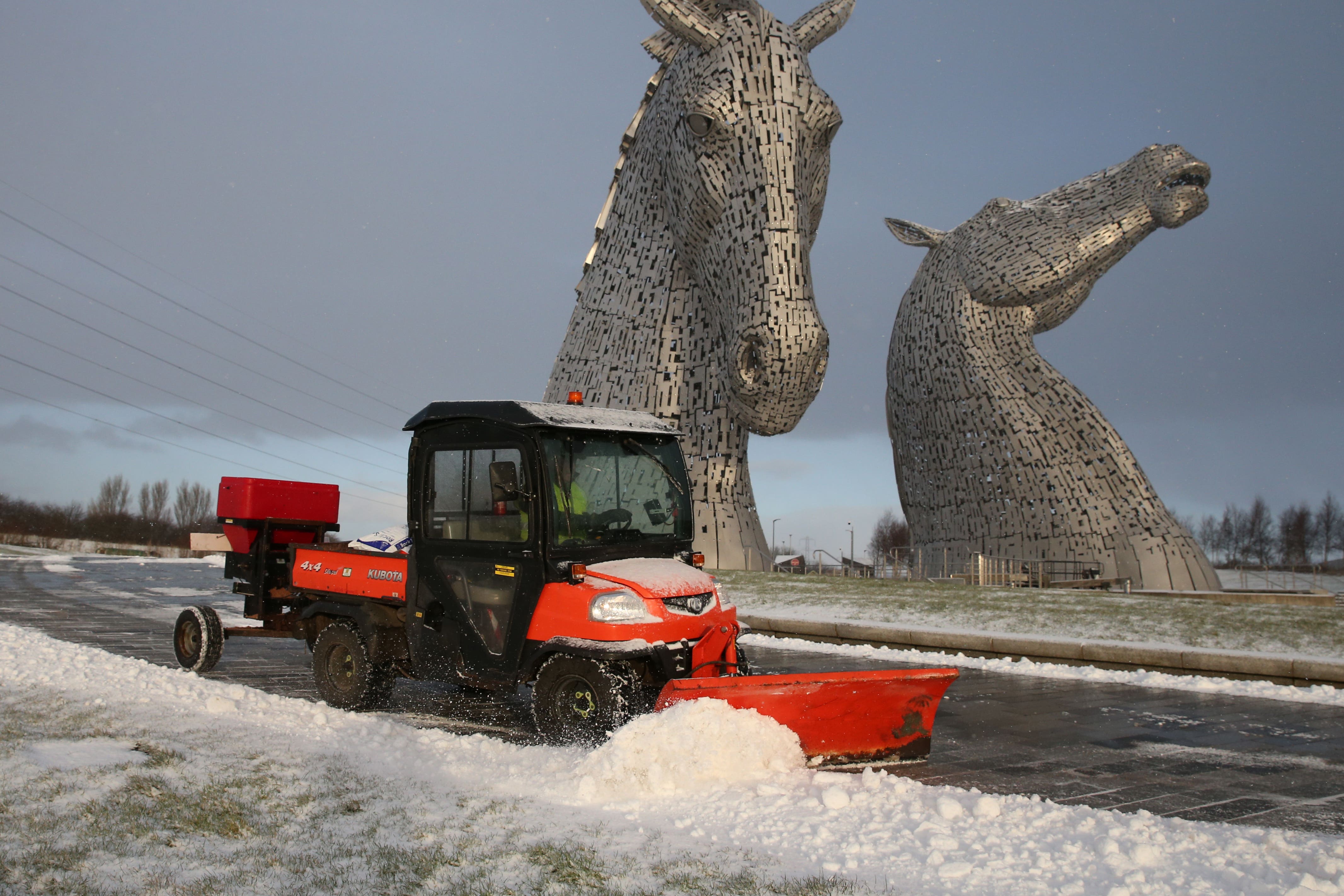 <p>A vehicle clears snow near the Kelpies in Falkirk</p>