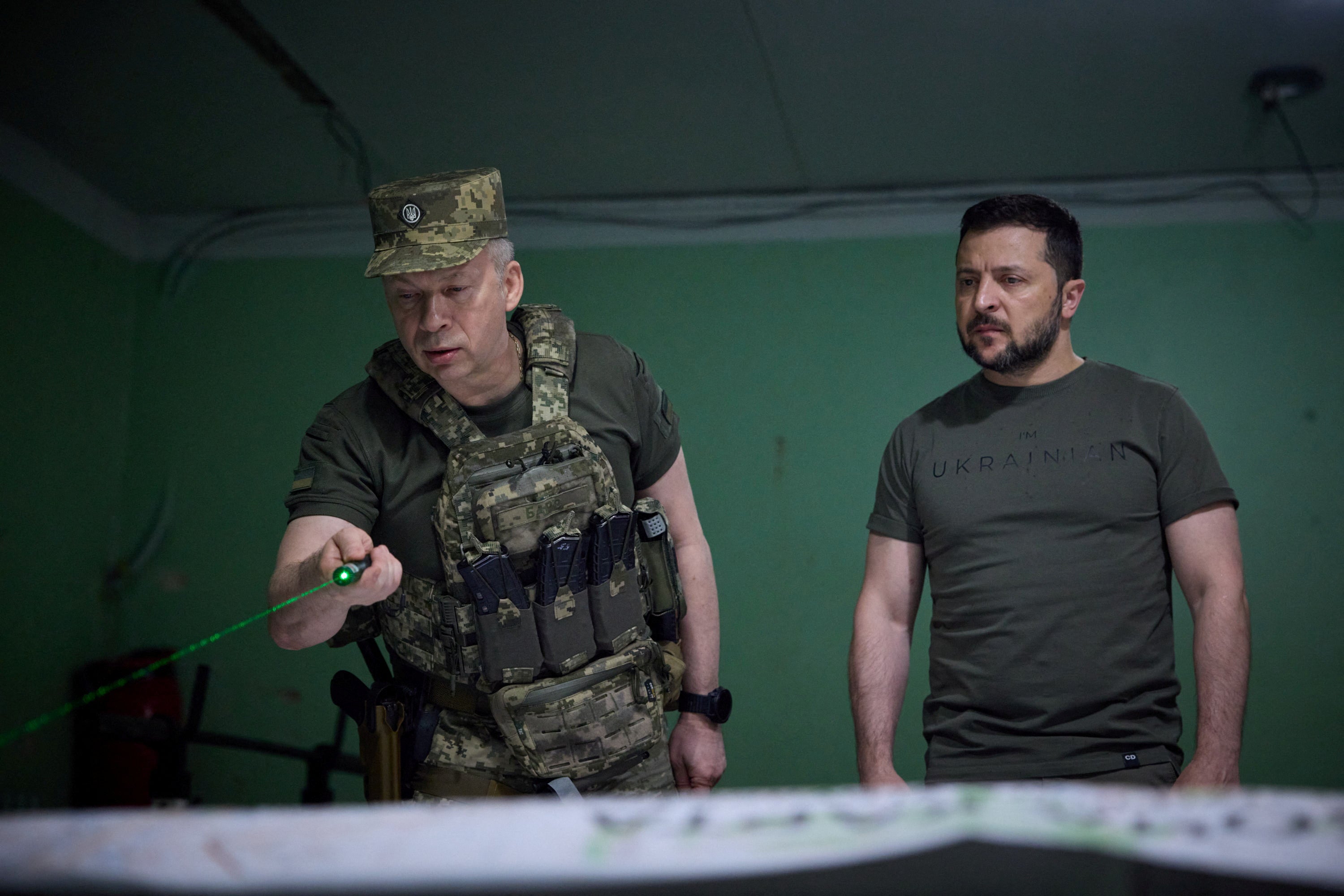 Ukraine’s President Volodymyr Zelenskiy listens a report of Commander of the Ground Forces colonel general Oleksandr Syrskyi