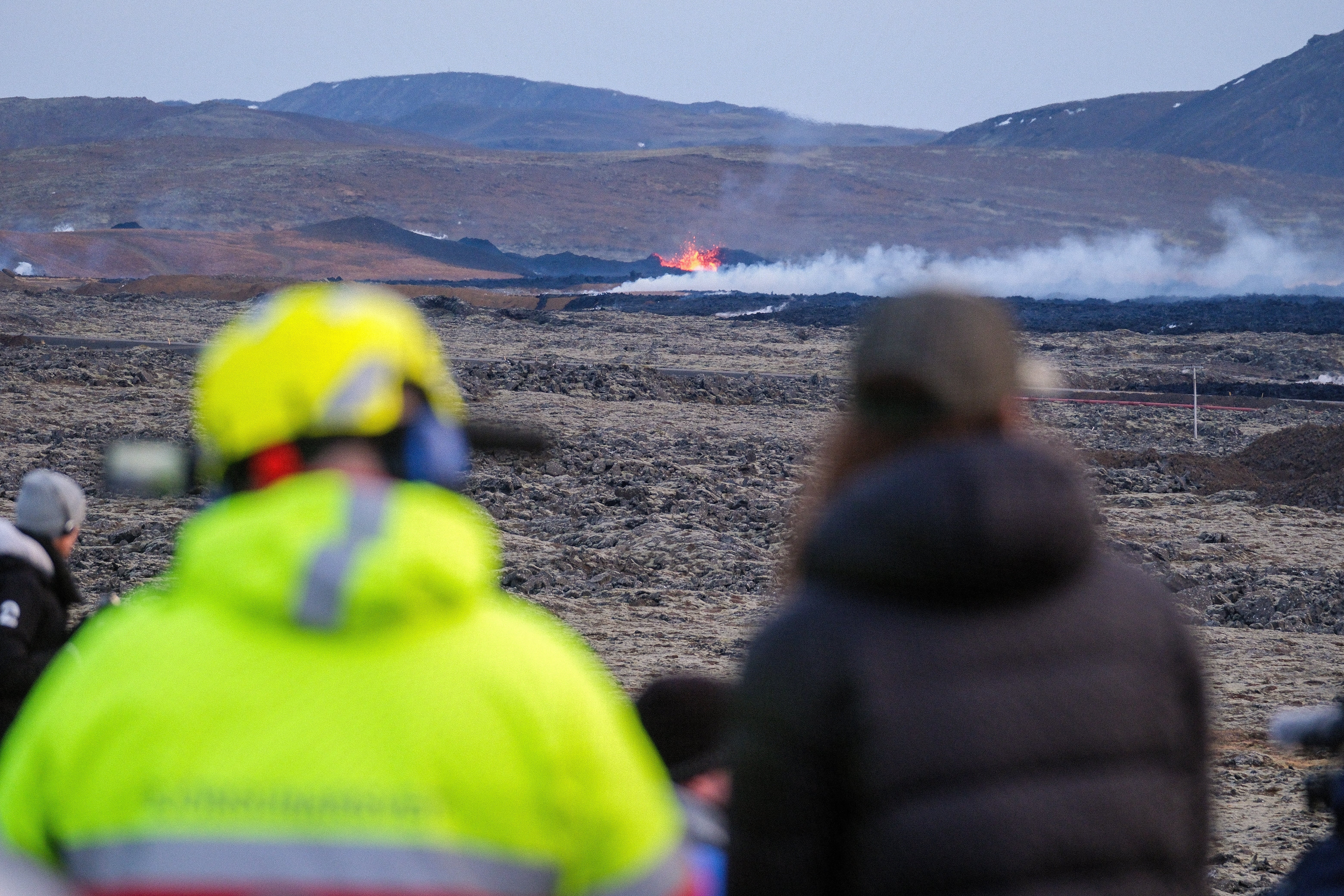 Lava explosions and rising smoke from a crack in the ground close to the town of Grindavik