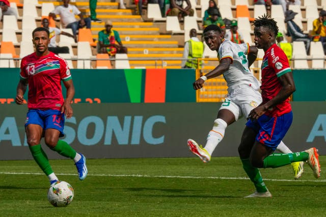 Lamine Camara (second right) scored twice as Senegal beat Gambia 3-0 (Sunday Alamba/AP)