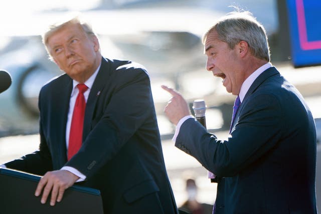 <p>US President Donald Trump listens as Nigel Farage (R) speaks during a Make America Great Again rally at Phoenix Goodyear Airport October 28, 2020, in Goodyear, Arizona</p>