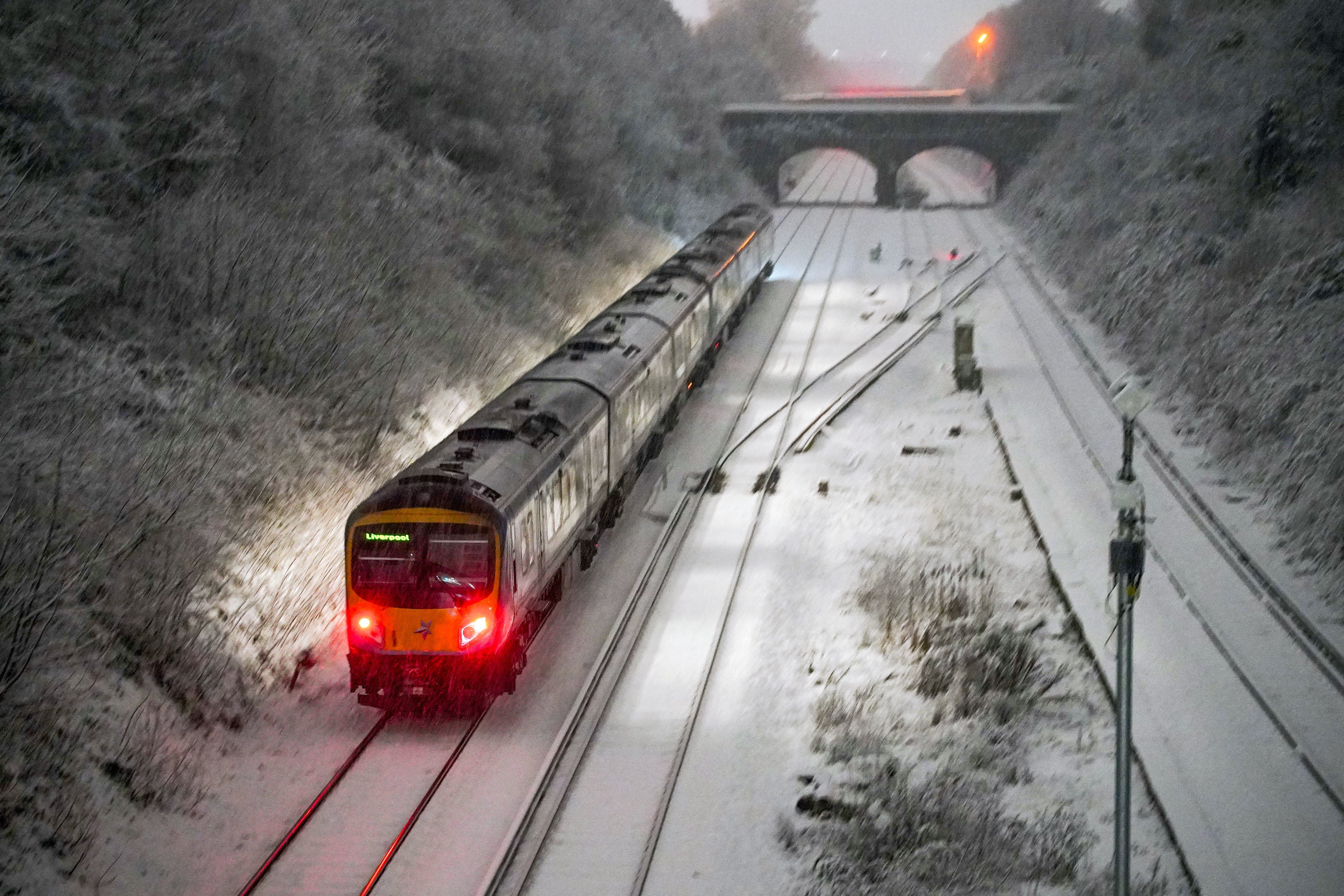 <p>Snow falls at Hunt Cross station, Liverpool</p>