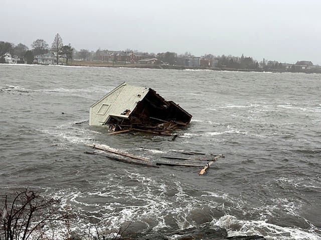 <p>A fishing shack floats away into Casco Bay during a storm in South Portland, Maine</p>