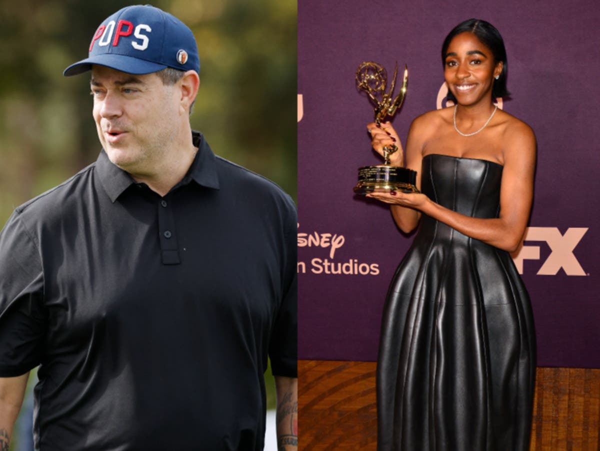 Carson Daly helps Ayo Edebiri with her purse after Emmy win