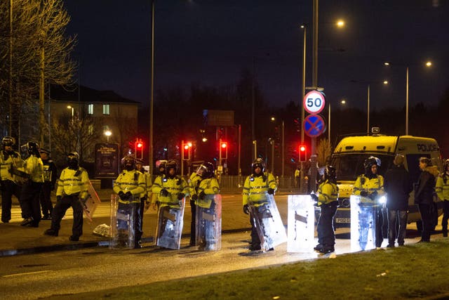 <p>Police in riot gear after a demonstration outside the Suites Hotel in Knowsley, Merseyside (Peter Powell/PA)</p>