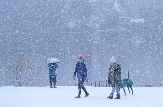<p>People walking in snowy conditions in Crow Park, Keswick in Cumbria</p>