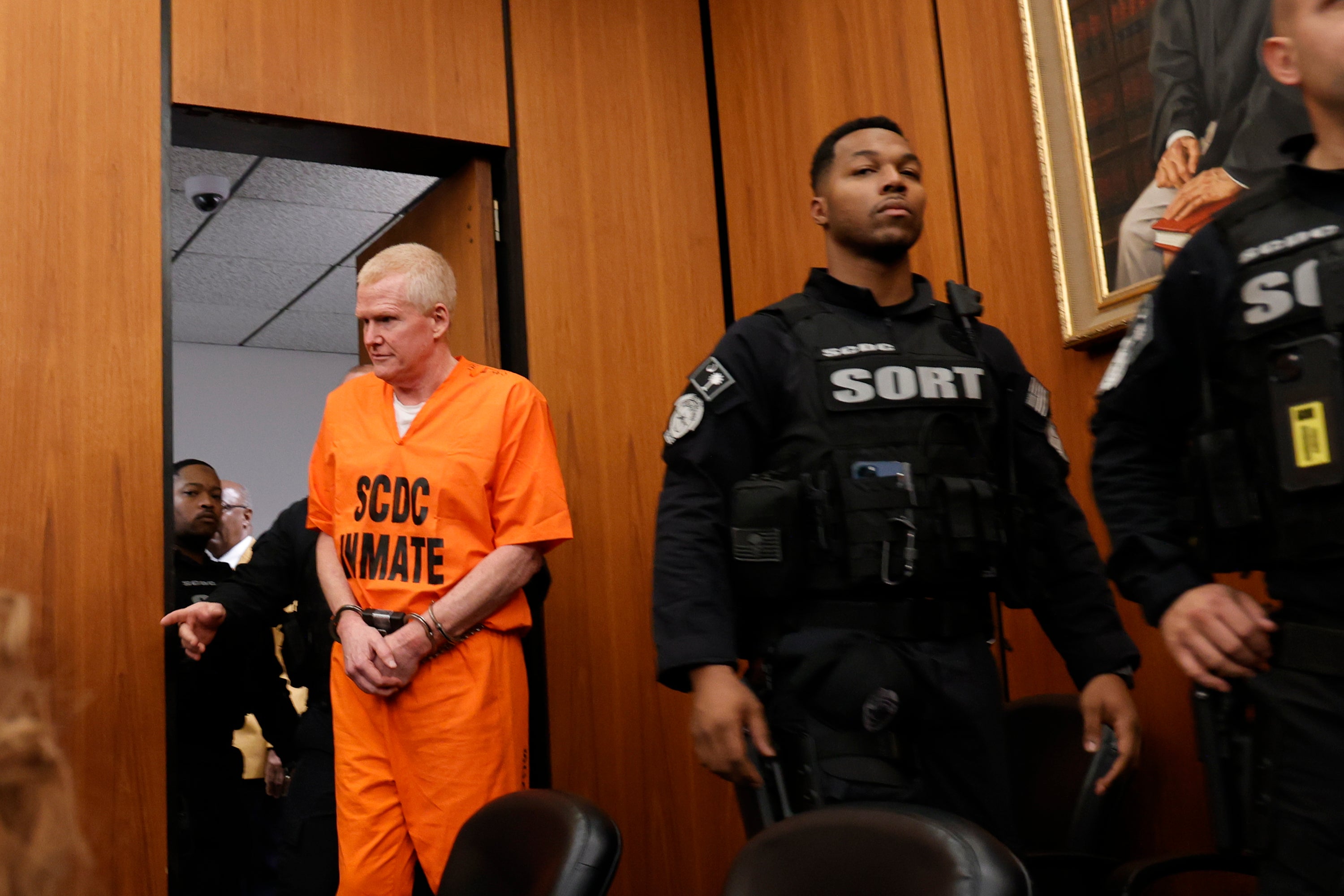 <p>Alex Murdaugh is escorted into the courtroom for a hearing on a motion for a retrial </p>