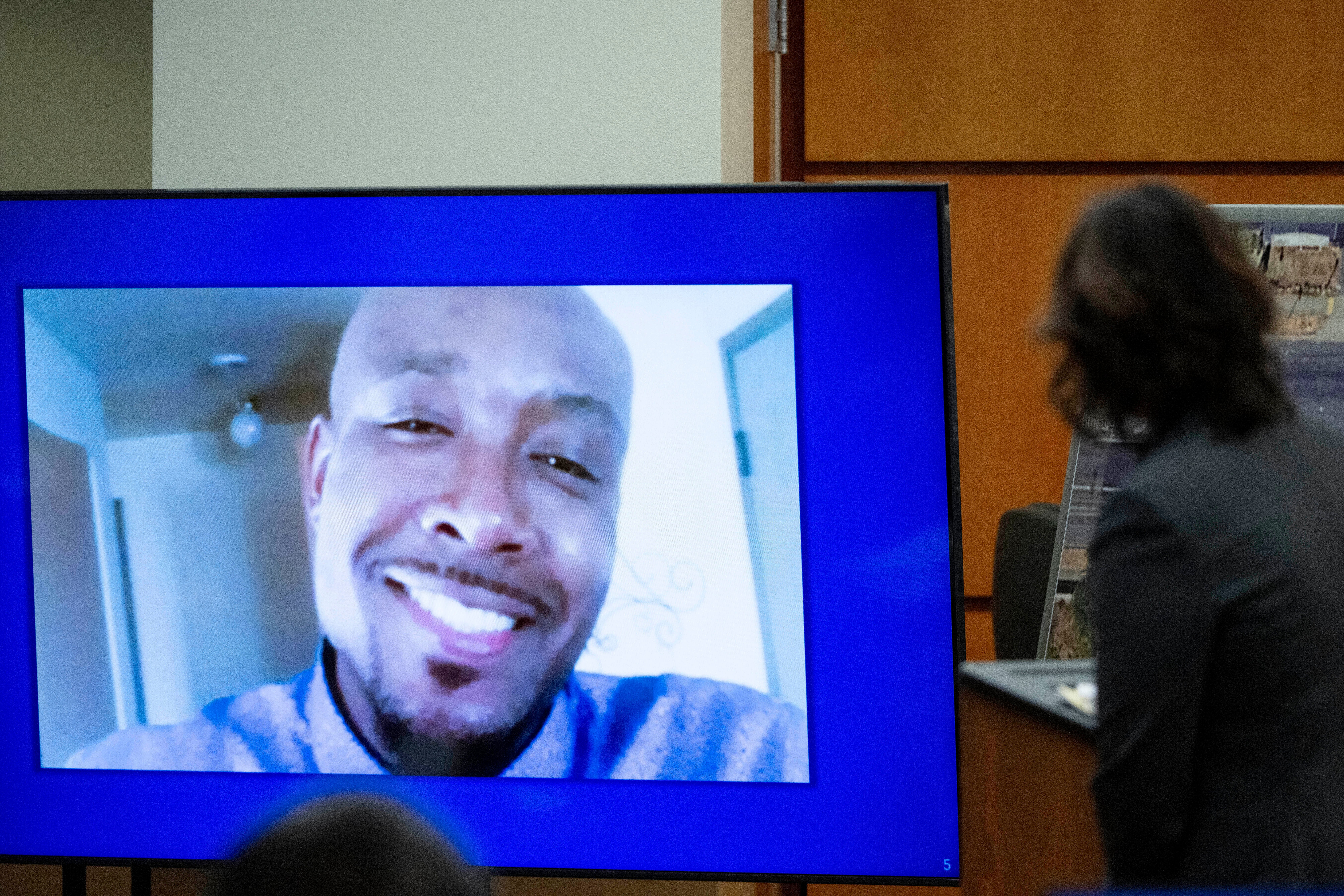 FILE - A photo of Manny Ellis is displayed while Special Assistant Attorney General Patty Eakes gives closing arguments during the trial of three Tacoma police officers in the killing of Ellis at Pierce County Superior Court, Dec. 11, 2023, in Tacoma, Wash.