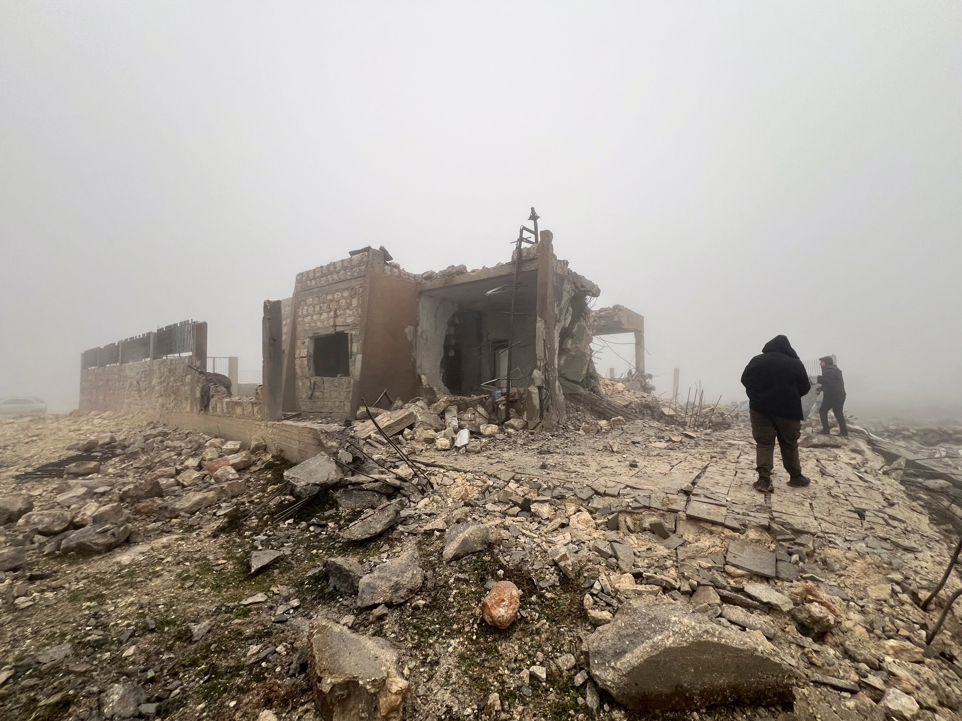 Syrians at an abandoned medical facility hit by Iran missiles in the village of Talteta