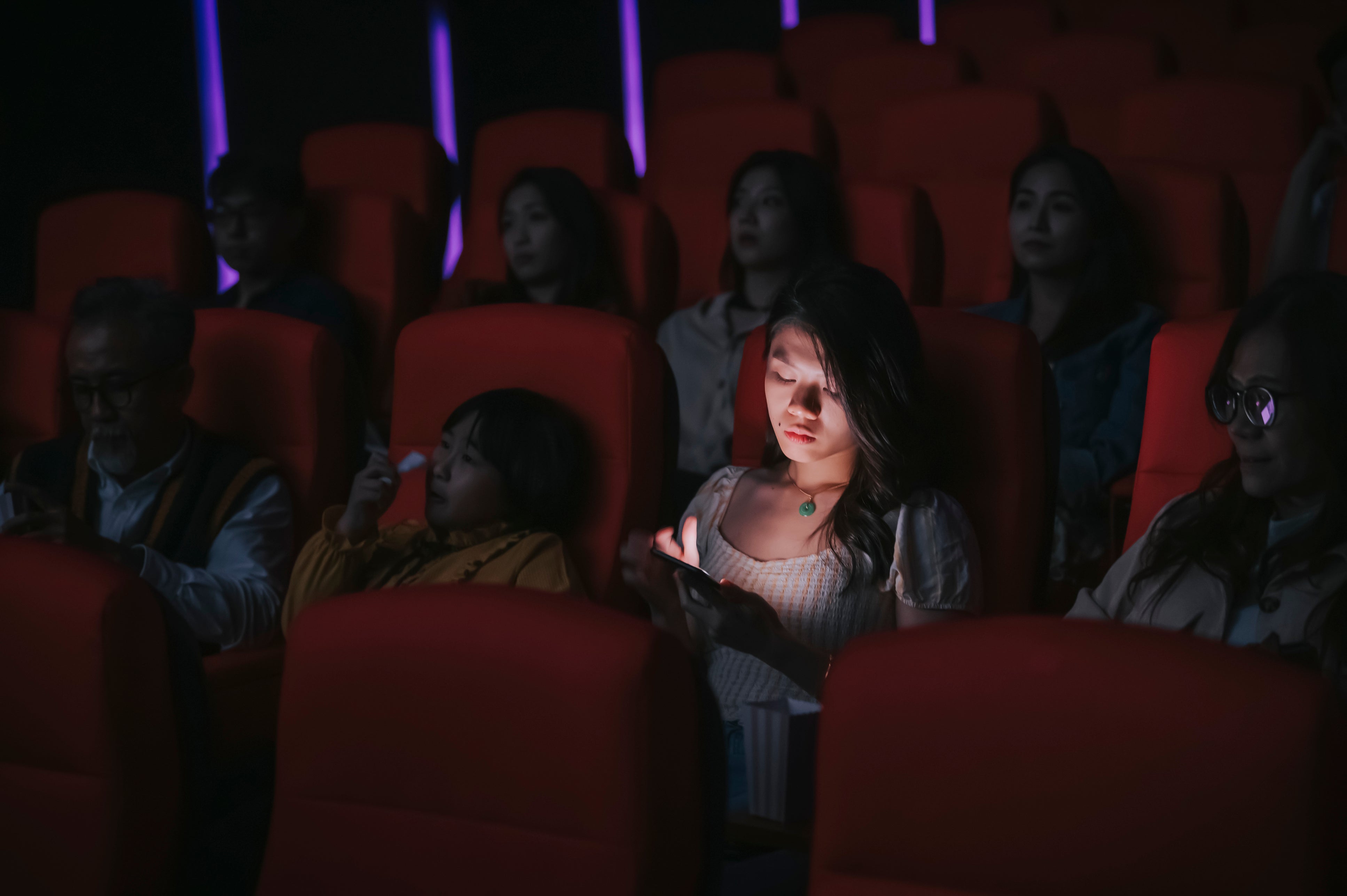 <p>Looking at mobile phones during performances is becoming more common </p>