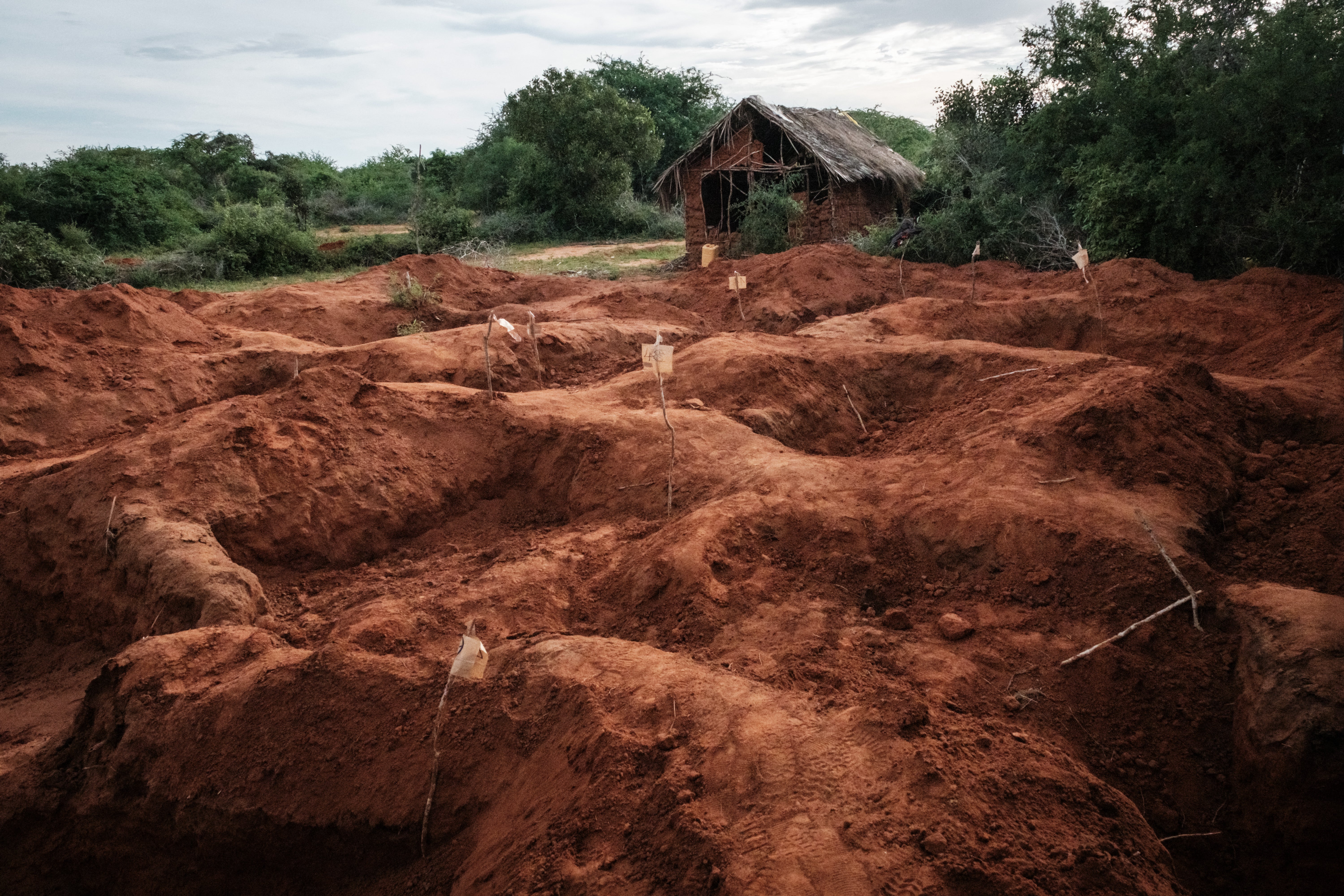 Digged holes are seen after exhuming bodies at the mass-grave site in Shakahola, outside the coastal town of Malindi