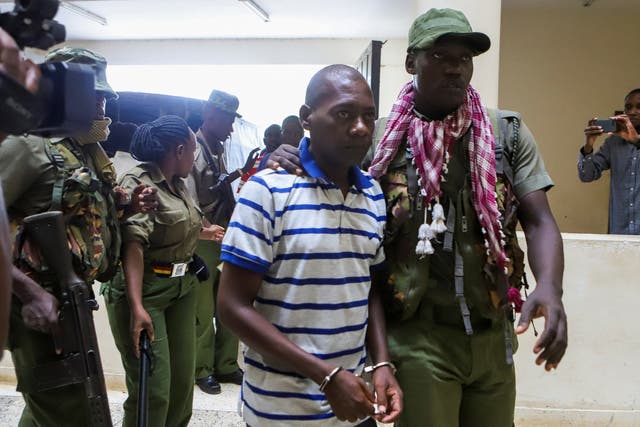 <p>Paul Mackenzie, a Kenyan cult leader accused of ordering his followers, is escorted to the Malindi Law Courts on Wednesday </p>