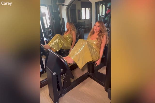 <p>Mariah Carey does gym workout wearing sequined gold gown and platform heels.</p>