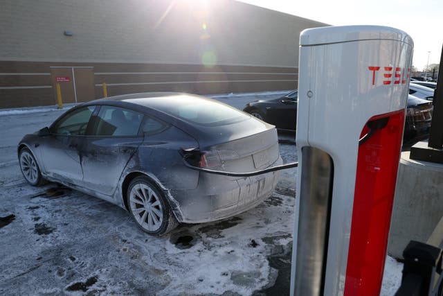 <p>A Tesla charges in an ice-covered parking lot on January 17, 2024 in Chicago, Illinois. A breakthrough in battery techonology could vastly improve power longevity for electric vehicles </p>