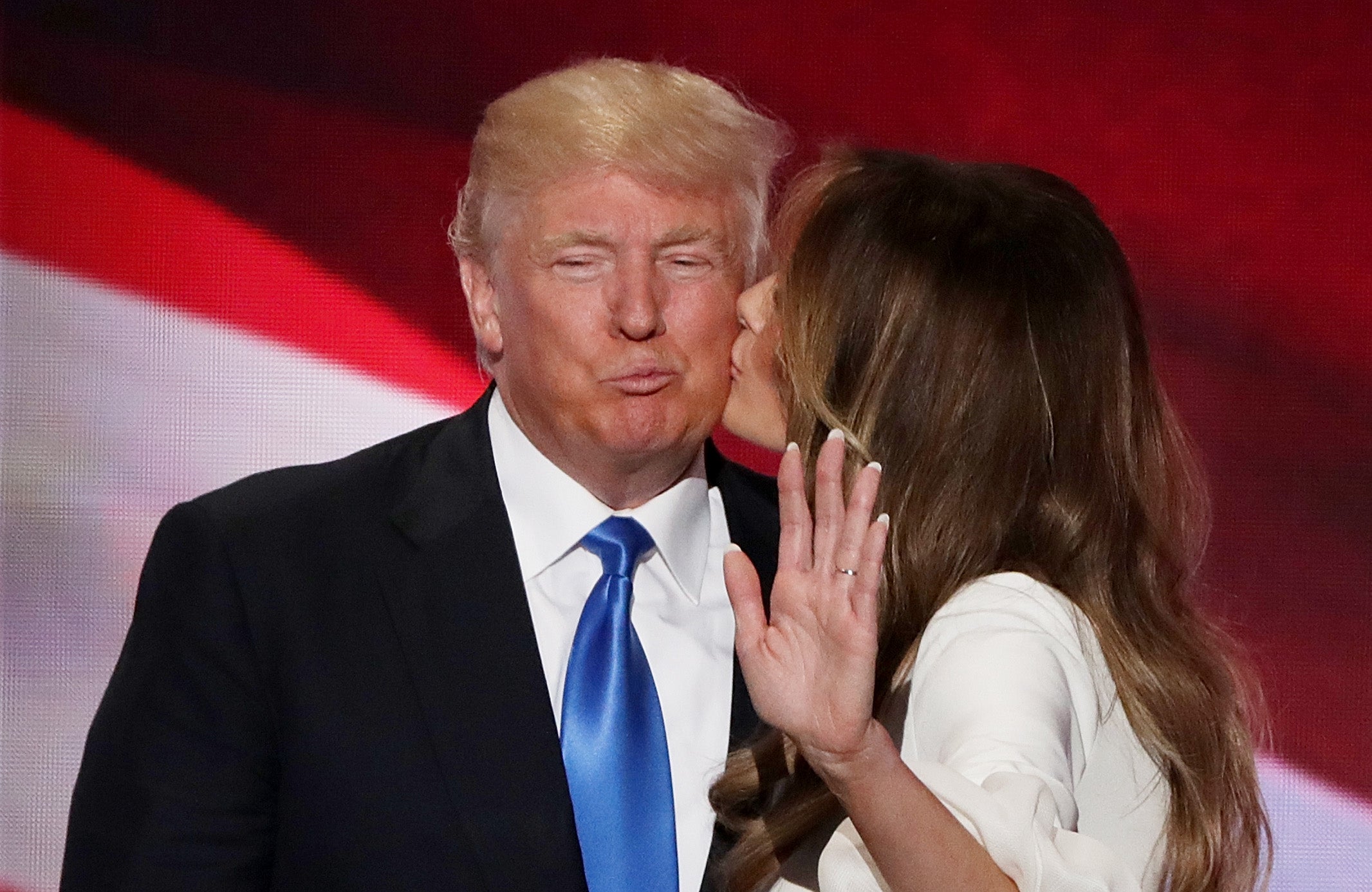 <p>Melania Trump kisses her husband and presumptive Republican presidential nominee Donald Trump</p>