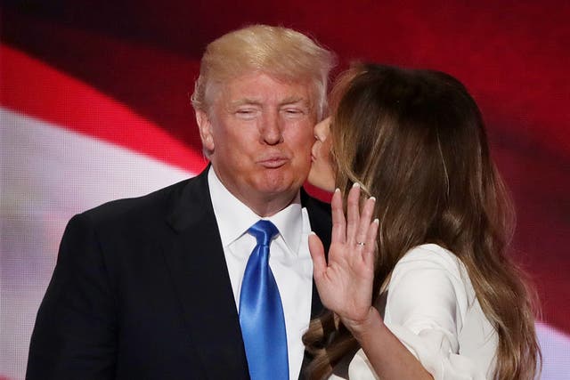 <p>Melania Trump kisses her husband and presumptive Republican presidential nominee Donald Trump</p>