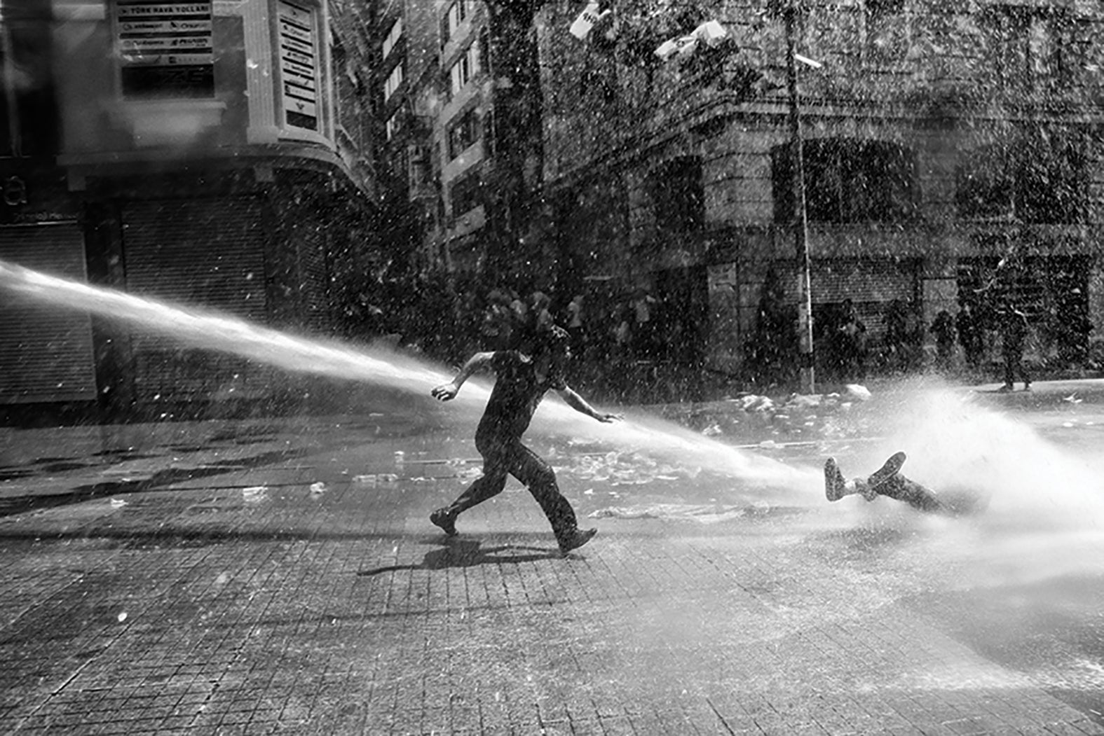 Police use water canon to disperse the crowd near Taksim Square in Istanbul. The civil unrest began in May 2013 after the violent eviction of a sit-in at Gezi park protesting an urban development plan