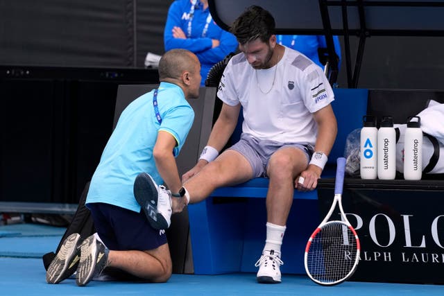 Cameron Norrie receives treatment from a trainer (Alessandra Tarantino/AP)