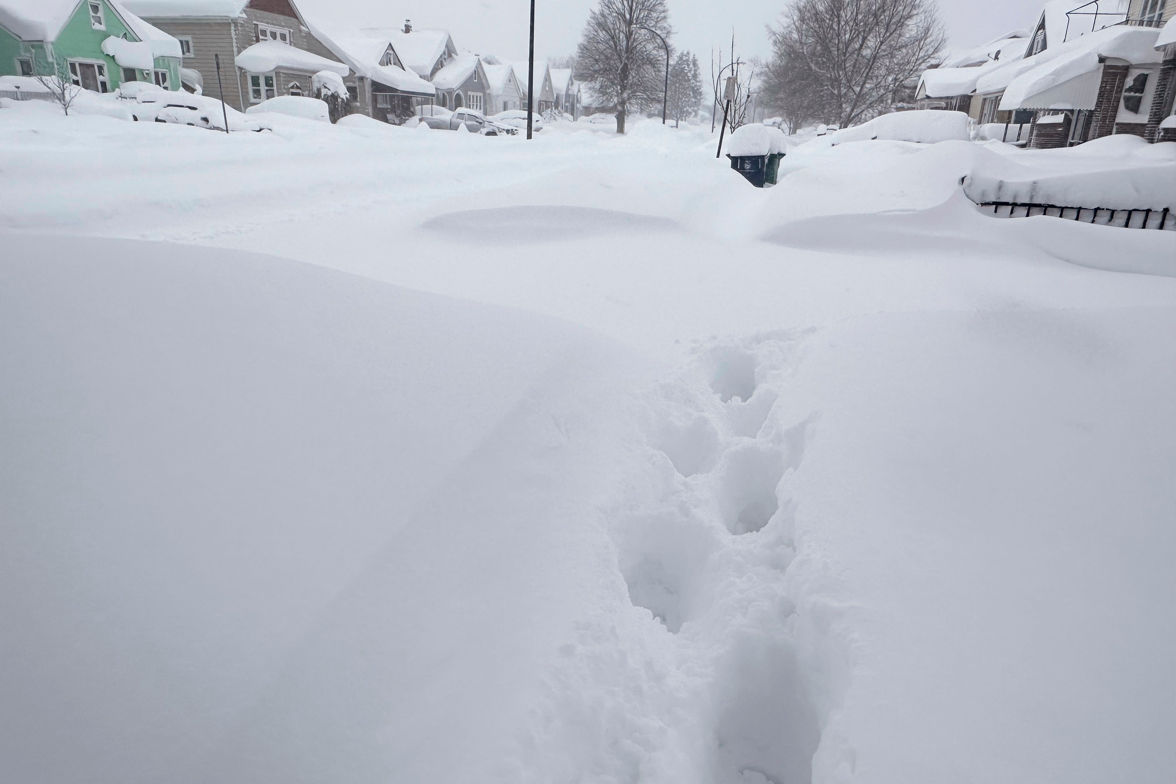 Footprints appear on a residential street after at least 18 inches of new snow fell overnight on Tuesday in Buffalo