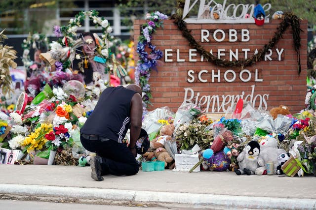 <p>Reggie Daniels pays his respects a memorial at Robb Elementary School, 9 June 2022, in Uvalde, Texas</p>