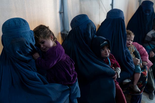 <p>Afghan burqa-clad women and children refugees deported from Pakistan, in a nutrition ward on the outskirts of Kabul</p>
