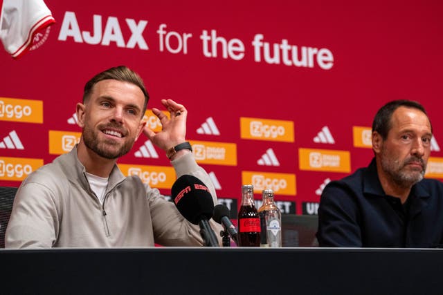 Jordan Henderson (left) and Ajax coach John van‘t Schip pictured during a press conference in Amsterdam (Peter Dejong/AP)