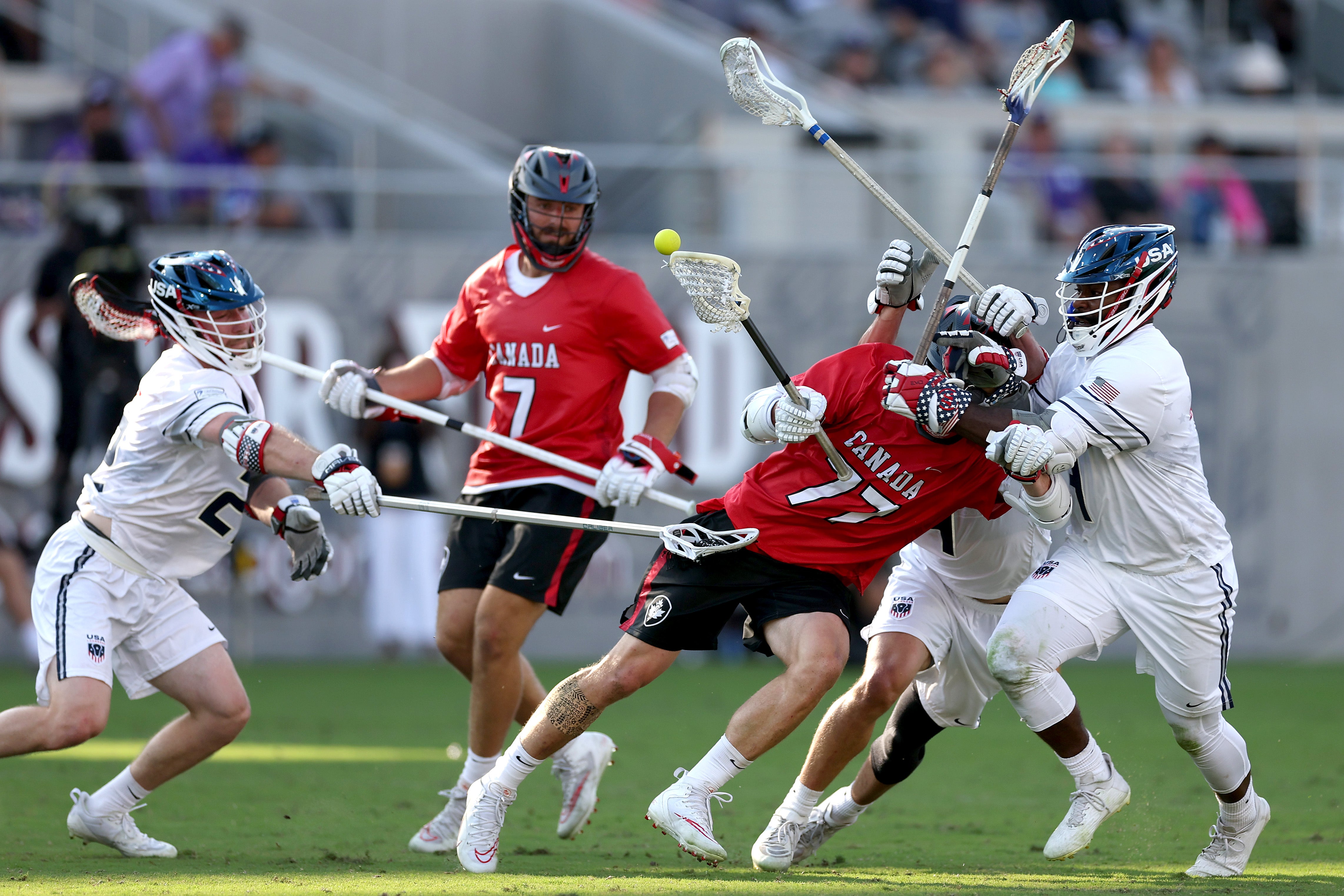 Zach Currier of Team Canada has the ball stripped from him by Trevor Baptiste of Team USA at the World Lacrosse Men’s gold medal match in 2023