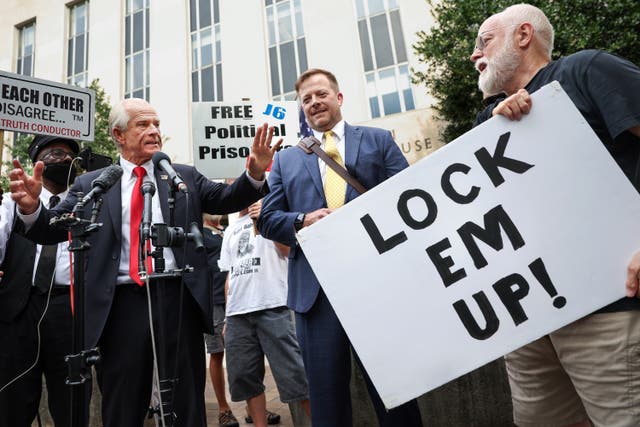 <p>Peter Navarro, an adviser to former US President Donald Trump, argues with a protester as he speaks to reporters after being found guilty of contempt of Congress at the E Barrett Prettyman Courthouse on 7 September 2023 in Washington, DC</p>