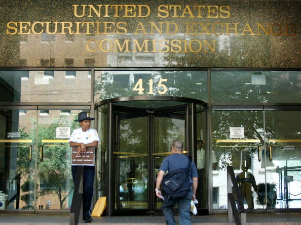 security guard stands outside of the Security and Exchange Commission offices August 14, 2002