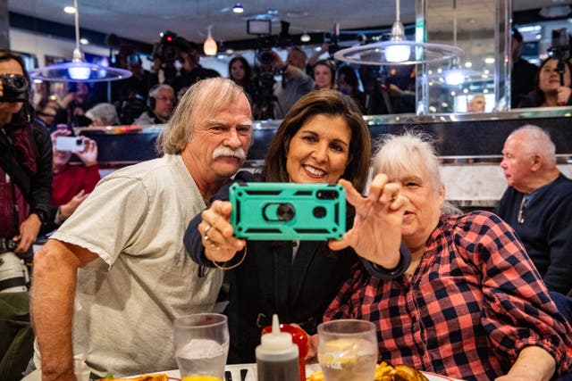 <p>Former UN ambassador and US 2024 Republican presidential hopeful Nikki Haley takes a selfie with voters at Mary Anne's Diner in Amherst, New Hampshire on January 19, 2024</p>